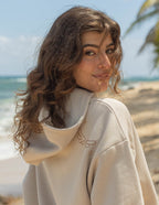 Elevated Faith Christian Hoodie in beige with stylish design, perfect for casual wear by the beach