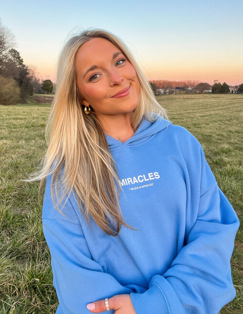 Elevated Faith Christian Hoodie in blue with 'Miracles' text for a stylish, faith-inspired look