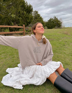 Elevated Faith Christian Hoodie in beige with 'Spirit of God' print, worn in a natural outdoor setting