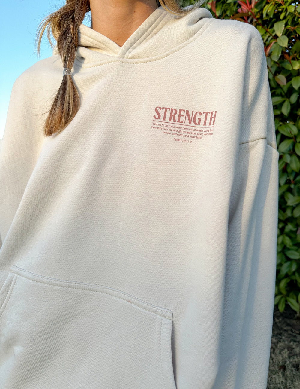 Elevated Faith Christian Hoodie in beige featuring 'Strength' graphic and front pocket