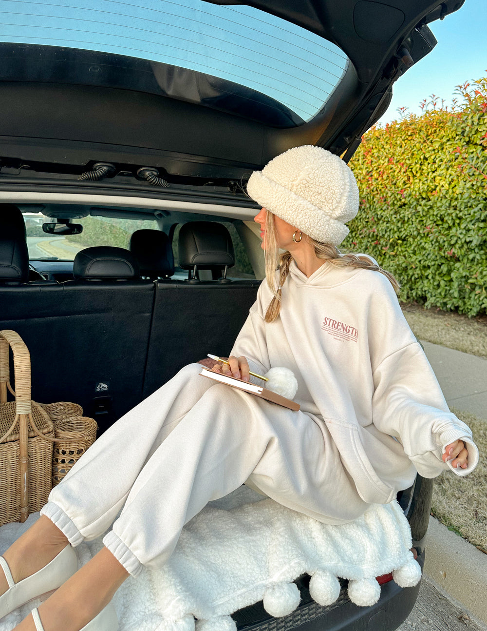 Elevated Faith Christian Hoodie in cream color with the word 'STRENGTH' printed on the front