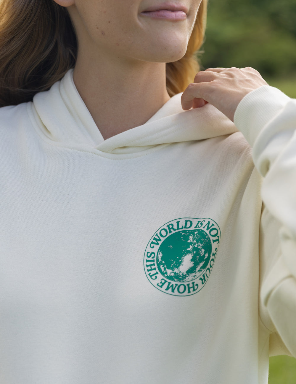 Elevated Faith Christian Hoodie in Cream featuring a globe graphic and inspirational text