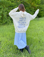 Elevated Faith Christian Hoodie with inspirational text on the back in a serene outdoor setting
