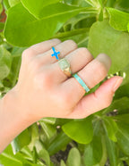 Elevated Faith Christian Jewelry with colorful rings featuring a cross design and inspirational text