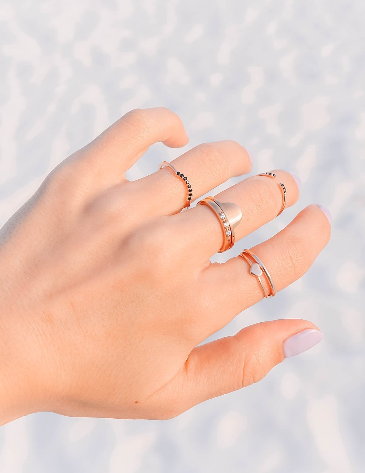 Collection of Elevated Faith Christian Jewelry Rings displayed on a hand with multiple styles