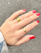 Elegant gold ring set on a hand with red nails, perfect Christian Jewelry for everyday wear