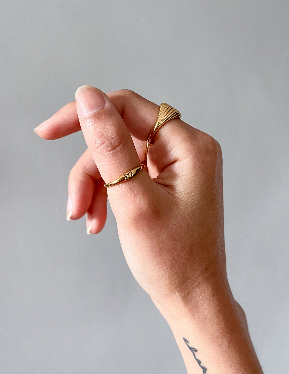 Elevated Faith Christian Jewelry Ring in Gold on a Hand with Elegant Design