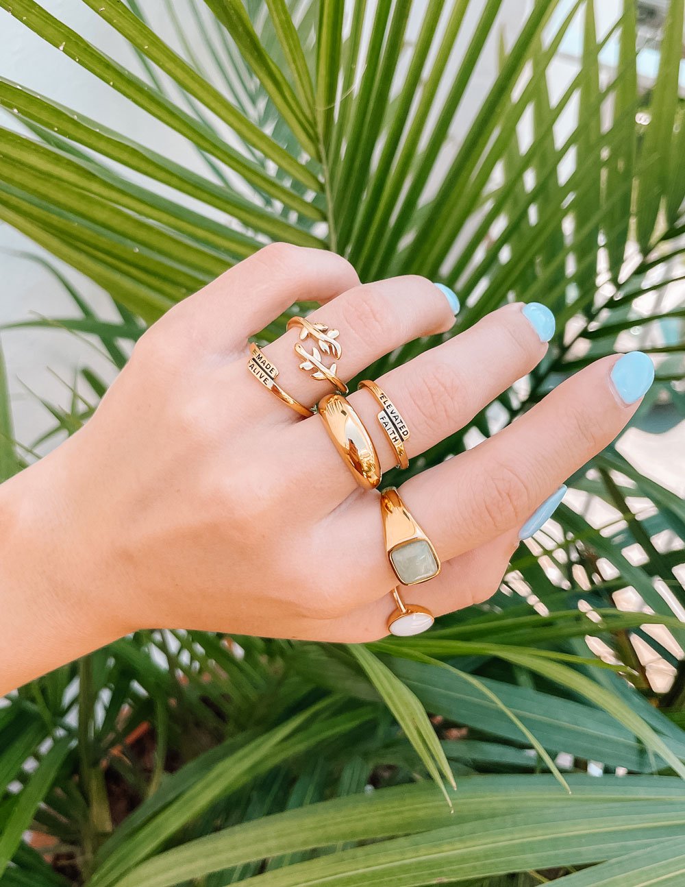 Elegant gold rings displayed on a hand, featuring unique designs for Christian Jewelry enthusiasts