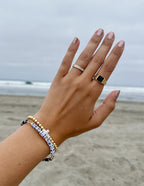 Elevated Faith Christian Jewelry Ring with a sleek design on a hand at the beach