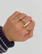 Stylish hand wearing multiple Elevated Faith rings showcasing Christian Jewelry designs