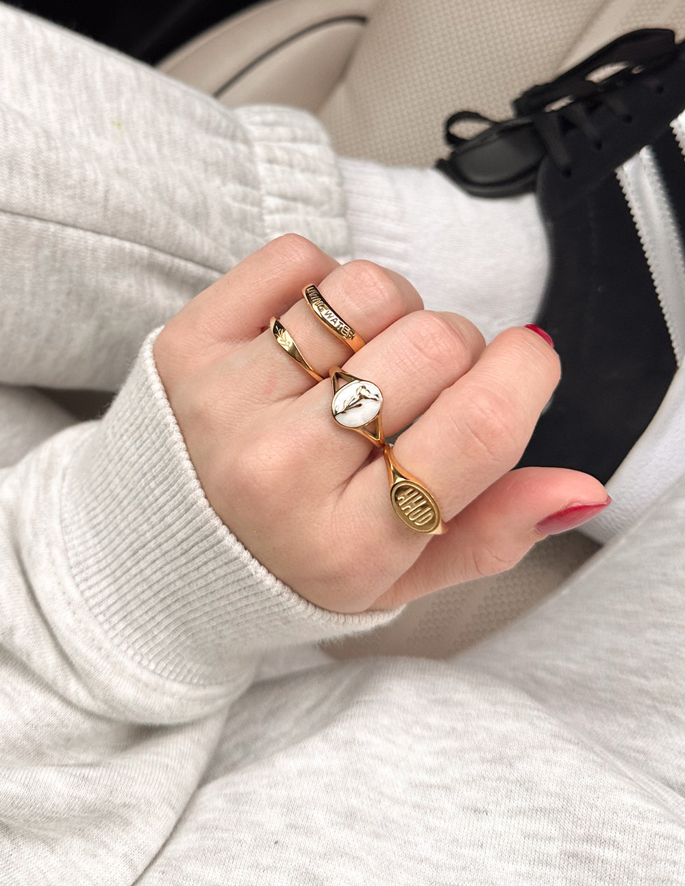Elevated Faith Christian Jewelry rings in gold on a hand showcasing stylish designs for faith-inspired fashion