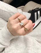 Gold Elevated Faith Christian Jewelry rings set on hand, featuring unique designs and a stylish look