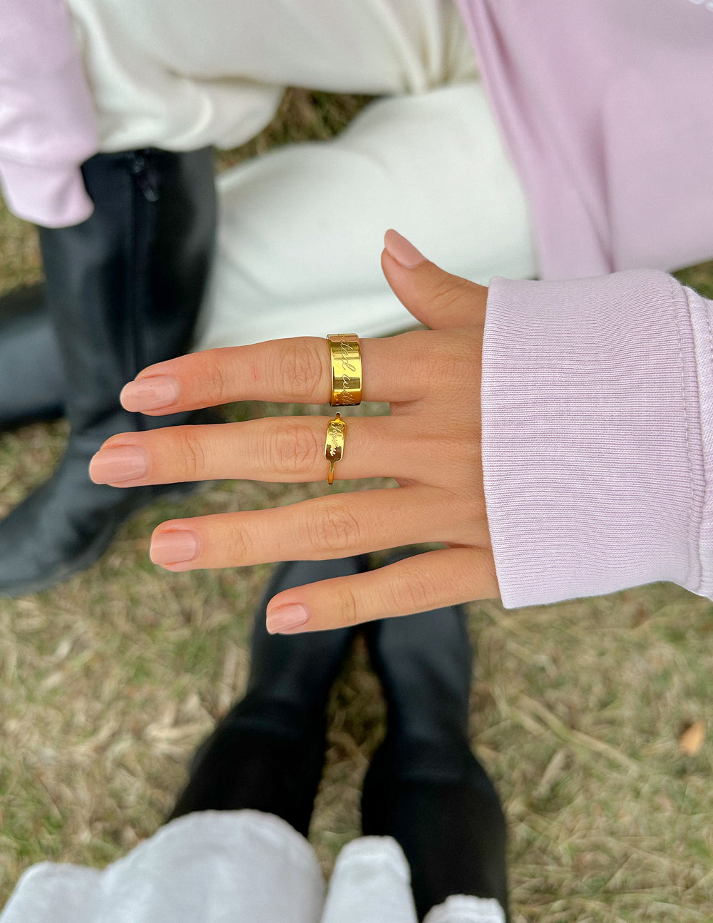 Elevated Faith gold ring on hand showcasing Christian Jewelry with engraved inspirational message