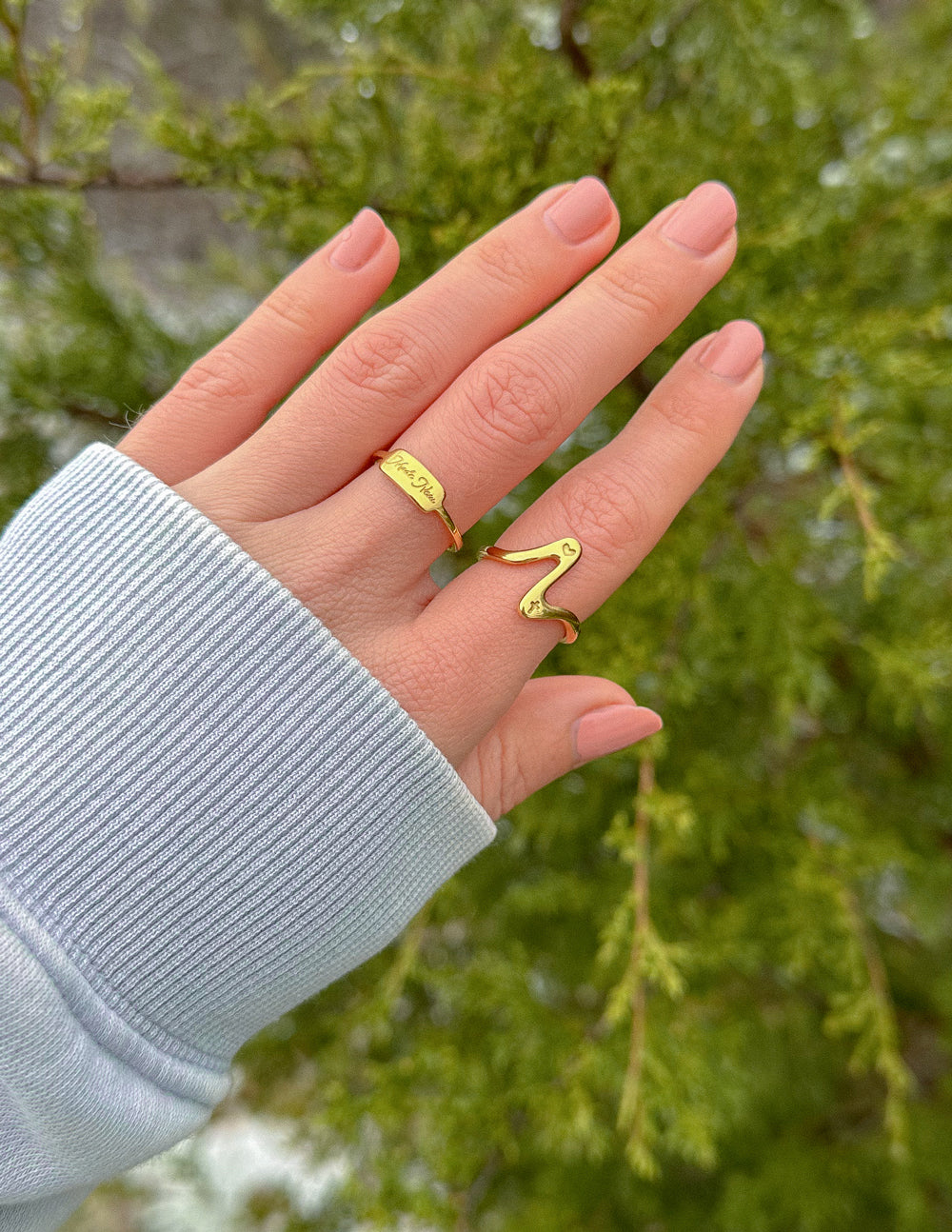 Elevated Faith Christian Jewelry Ring in Gold on a Hand against Natural Background