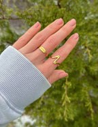Elevated Faith Christian Jewelry Ring in Gold on a Hand against Natural Background