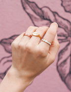 Three stylish rings from Elevated Faith showcasing elegant Christian Jewelry on a hand