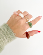 Assorted rings displayed on a hand, showcasing unique designs of Elevated Faith Christian Jewelry