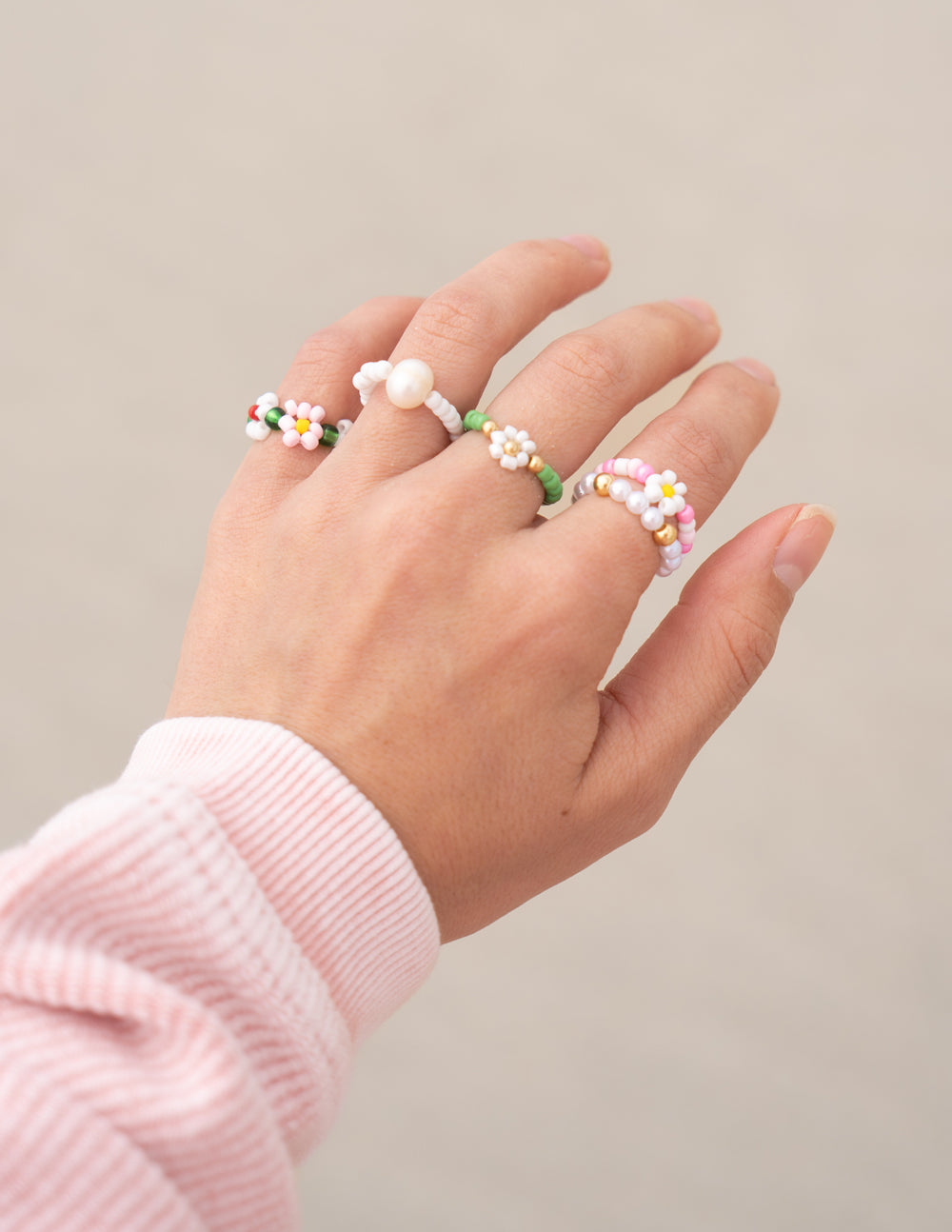 Colorful beaded rings displayed on a hand, showcasing Elevated Faith Christian Jewelry style