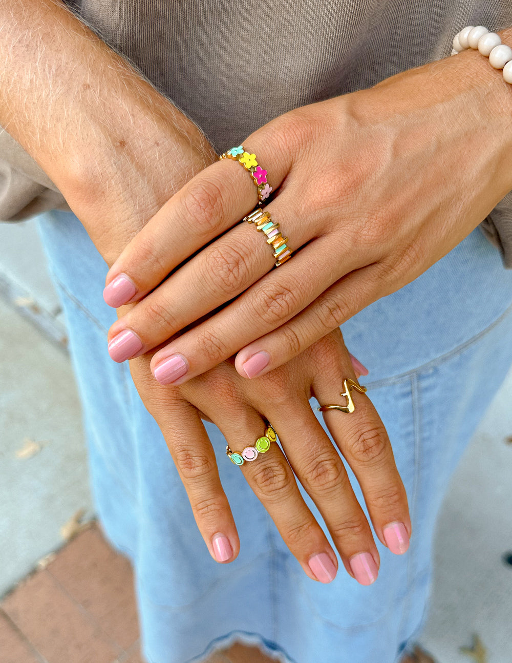 Colorful Elevated Faith rings on hands, showcasing beautiful Christian Jewelry for everyday wear