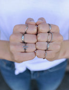 Collection of Elevated Faith Christian Jewelry rings displayed on hands with various designs and styles