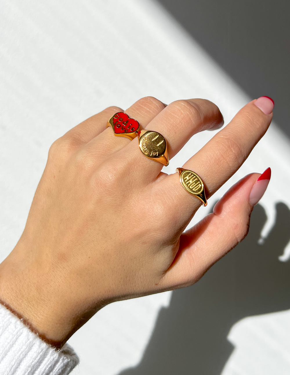 Three gold rings featuring unique designs, ideal for Christian Jewelry enthusiasts