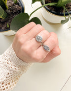 Elevated Faith Christian Jewelry featuring a stylish silver ring on a hand among potted plants