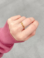 Gold love ring showcased on a hand, perfect for Christian Jewelry enthusiasts