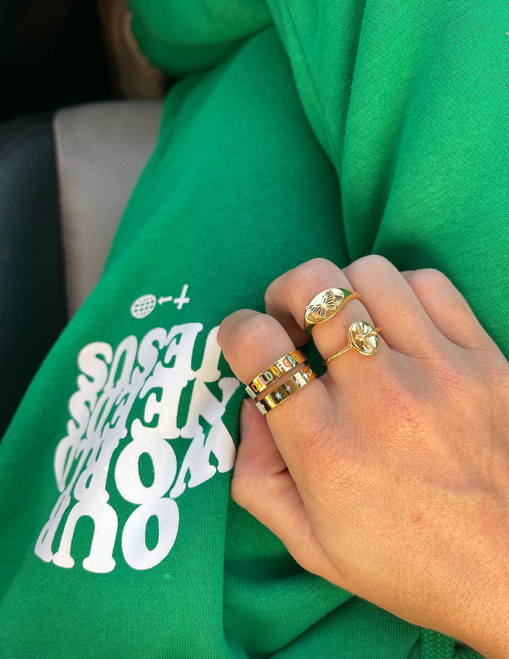 Elevated Faith Christian Jewelry rings displayed on a hand wearing green sweatpants