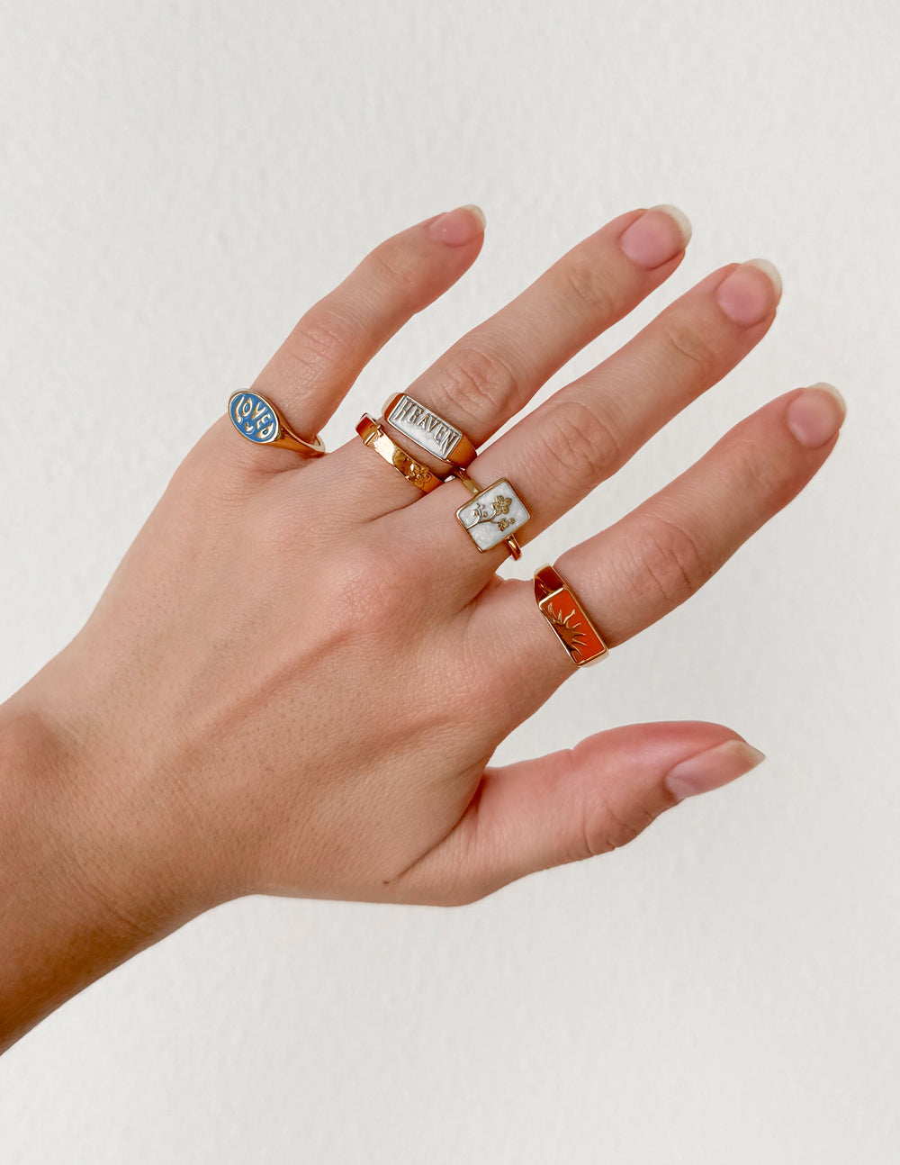 Set of Elevated Faith Christian Jewelry Rings on a model's hand with various designs