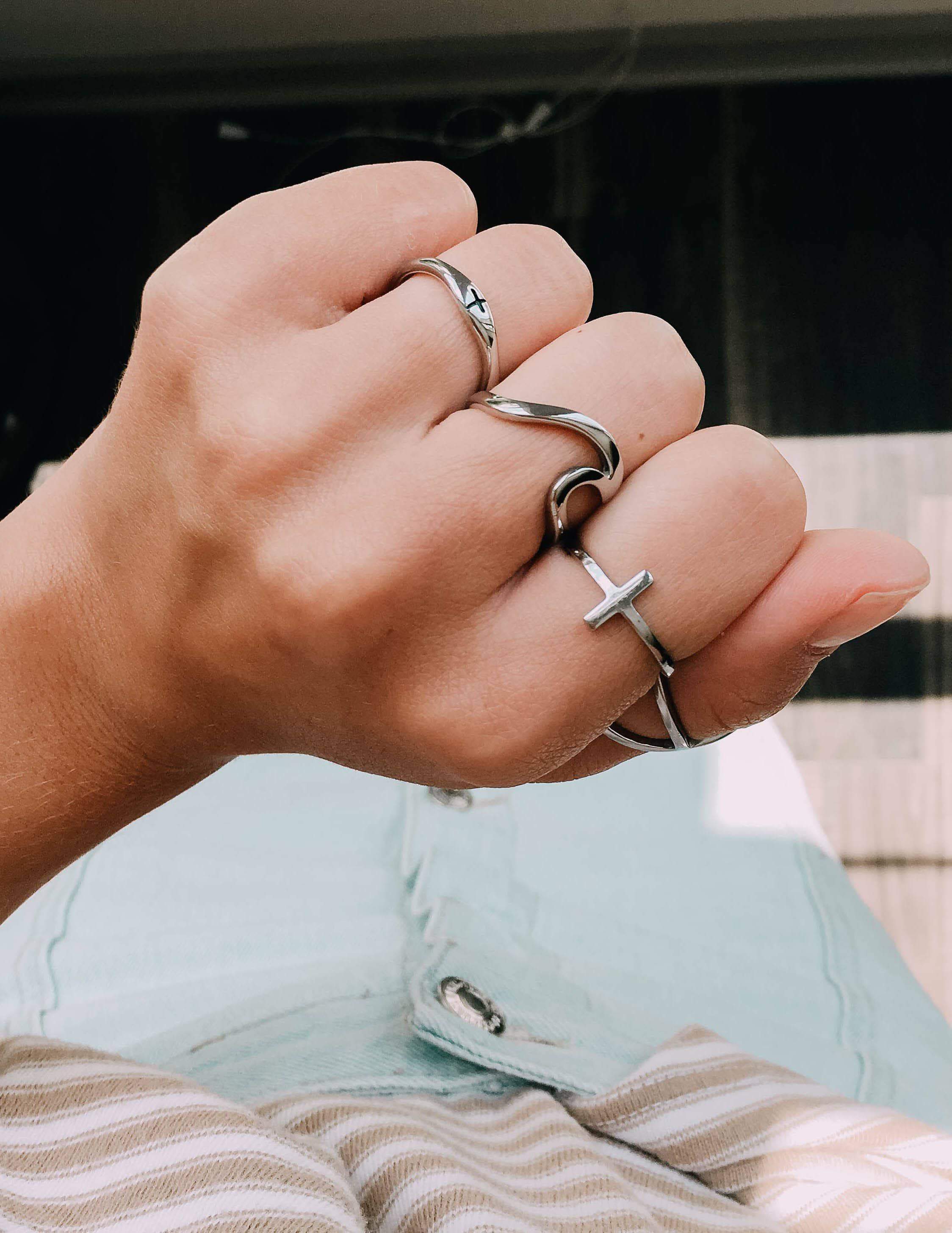 Stylish Elevate Faith Christian Jewelry rings worn on a hand showcasing faith-inspired designs
