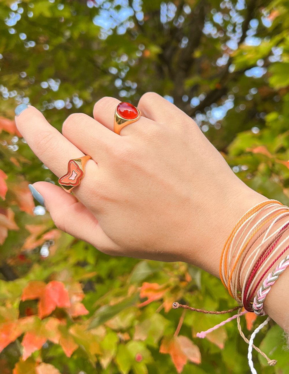 Stylish Elevated Faith rings in gold featuring colorful designs, perfect for Christian jewelry enthusiasts