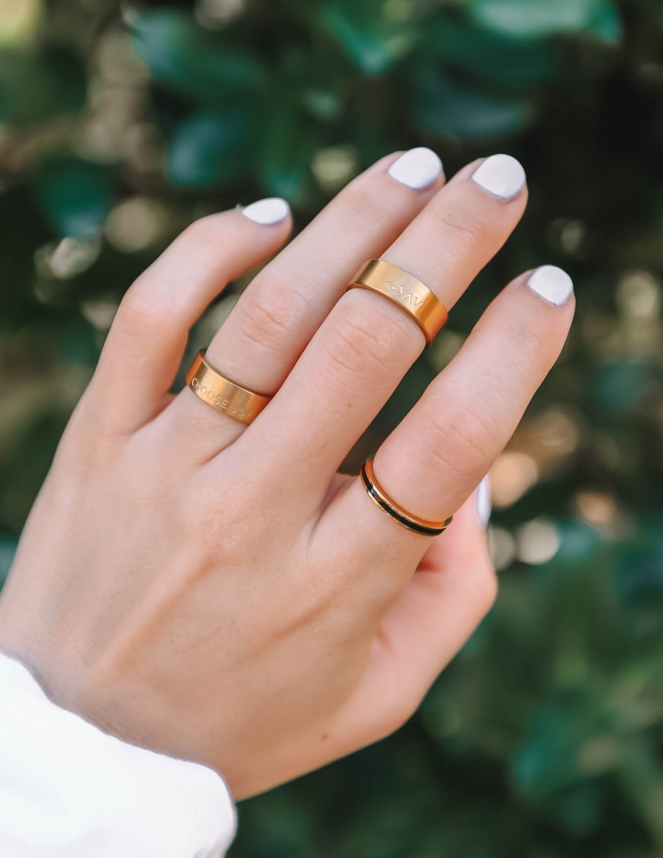 Elevated Faith Gold Rings Stack for Women showcasing beautiful Christian Jewelry in a natural setting