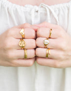 Gold rings displayed on hands showcasing Elevated Faith Christian Jewelry for stylish faith expression