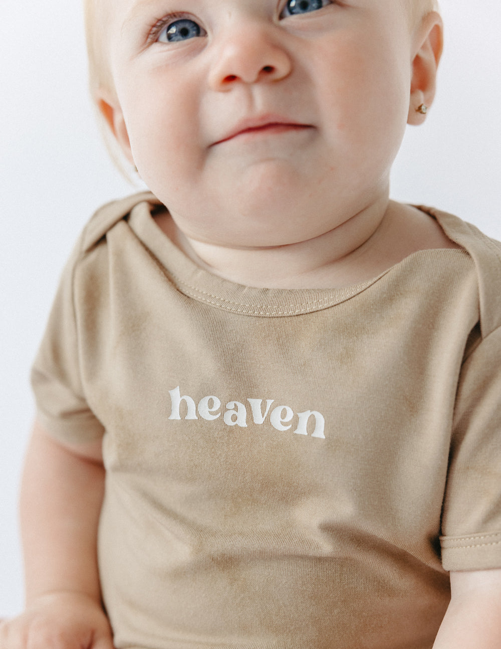 Tan onesie for infants with 'heaven' print, perfect for Christian Kids Apparel and everyday wear