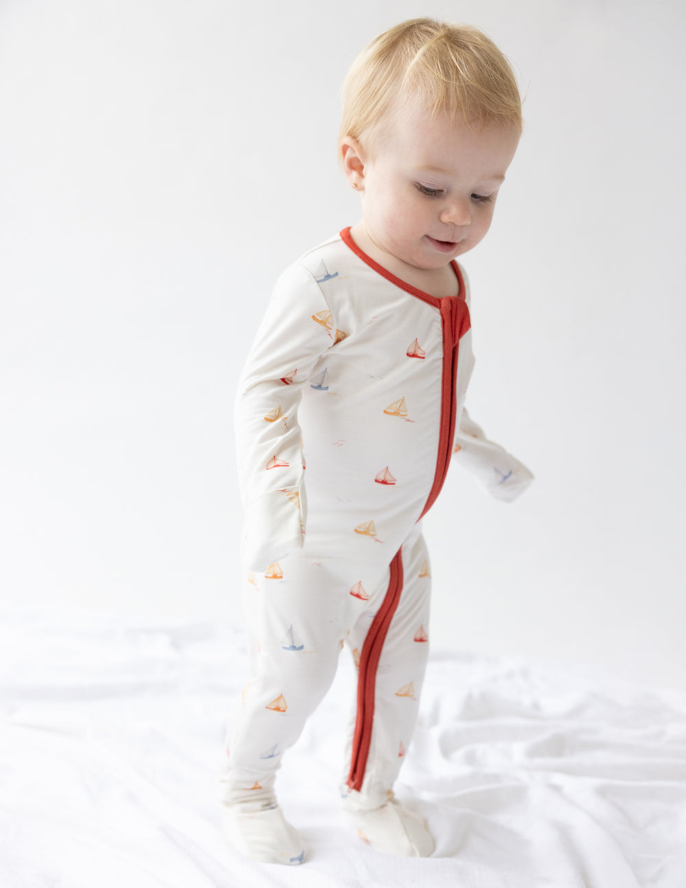 Elevated Faith Christian Kids Apparel featuring a sailboat pattern on a cozy onesie for infants