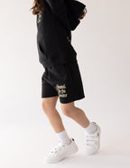 Black Kids Shorts by Elevated Faith featuring 'Created by the Creator' text, part of Christian Kids Apparel