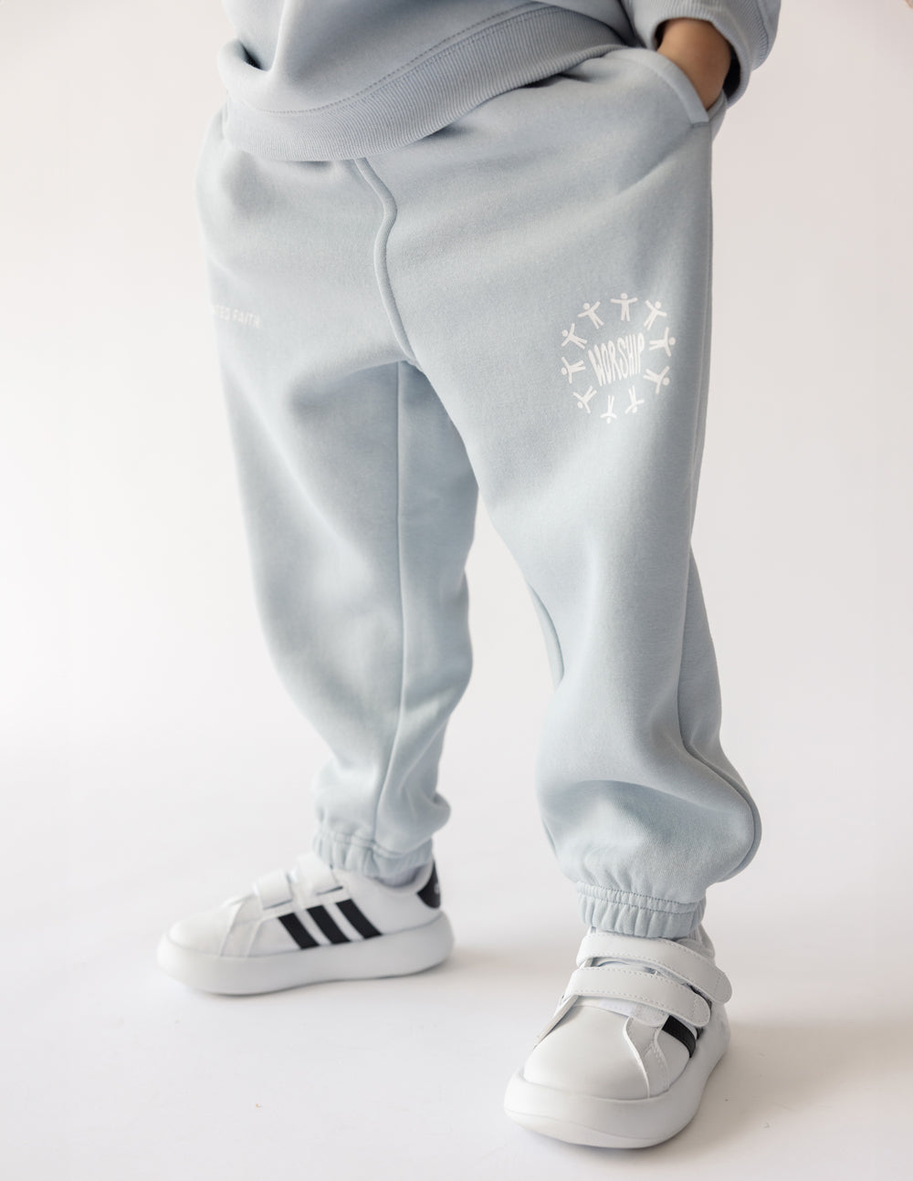 Light blue kids sweatpants by Elevated Faith featuring a Christian Kids Apparel design with graphic print