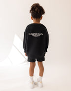 Black Elevated Faith Kids Crewneck featuring 'Powered by God' for trendy Christian Kids Apparel