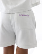 White kids shorts from Elevated Faith featuring a stylish logo, perfect for Christian Kids Apparel