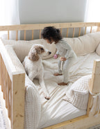 Cozy Elevated Faith Christian Kids Apparel Pajamas on a child playing with a dog in a soft bedding setting