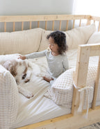 Child in Elevated Faith Kids Pajama playing with a dog, perfect for Christian Kids Apparel