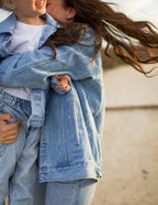 Mom and child wearing matching denim jackets from Elevated Faith, perfect Christian Kids Apparel for family bonding.