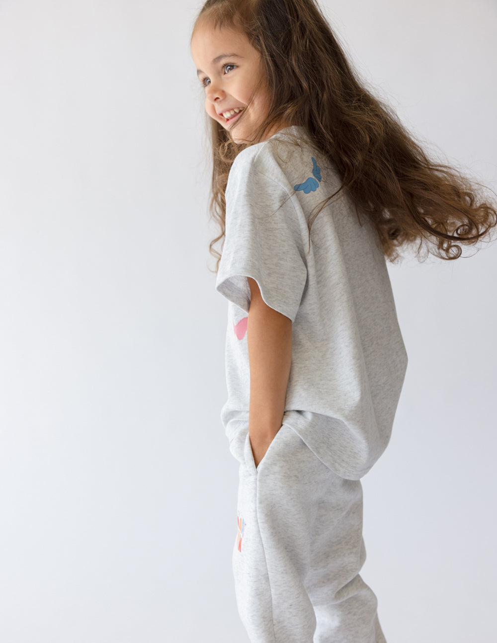 Smiling girl wearing a grey Kids T-Shirt from Elevated Faith, part of Christian Kids Apparel