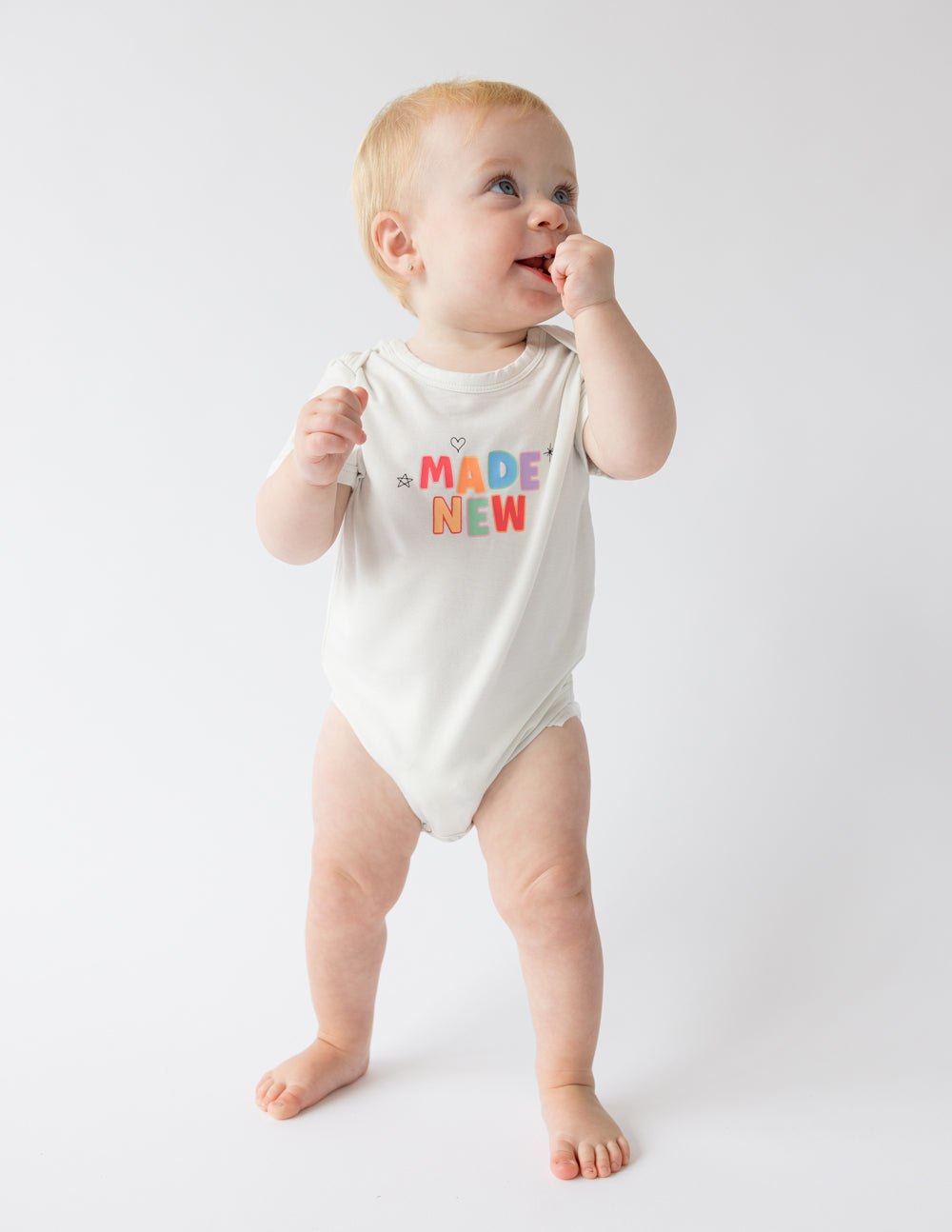 Elevated Faith Christian Kids Apparel Onesie in white with colorful 'MADE NEW' print design for toddlers