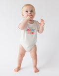 Light beige onesie for infants with colorful 'Made New' text, ideal Christian Kids Apparel