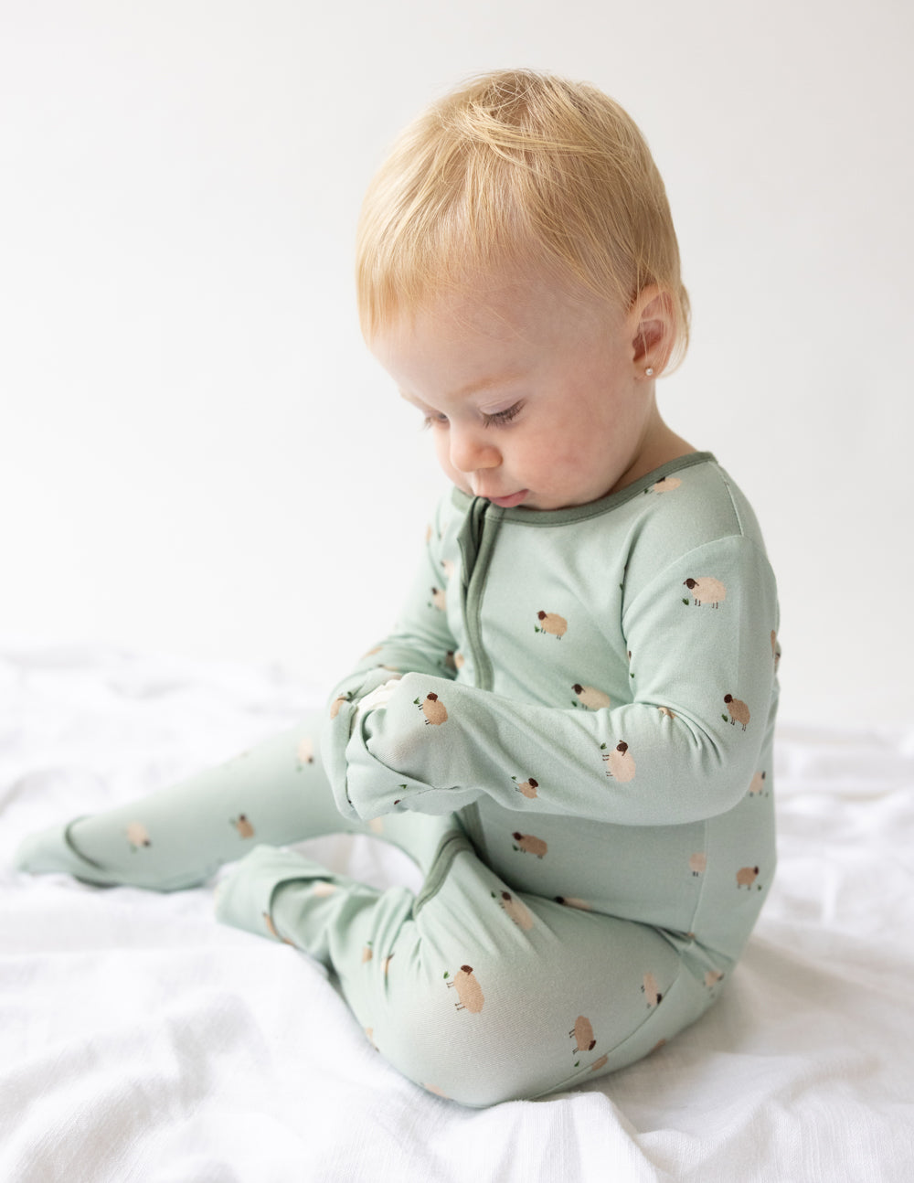 Soft green onesie for toddlers featuring adorable animal prints, part of Christian Kids Apparel