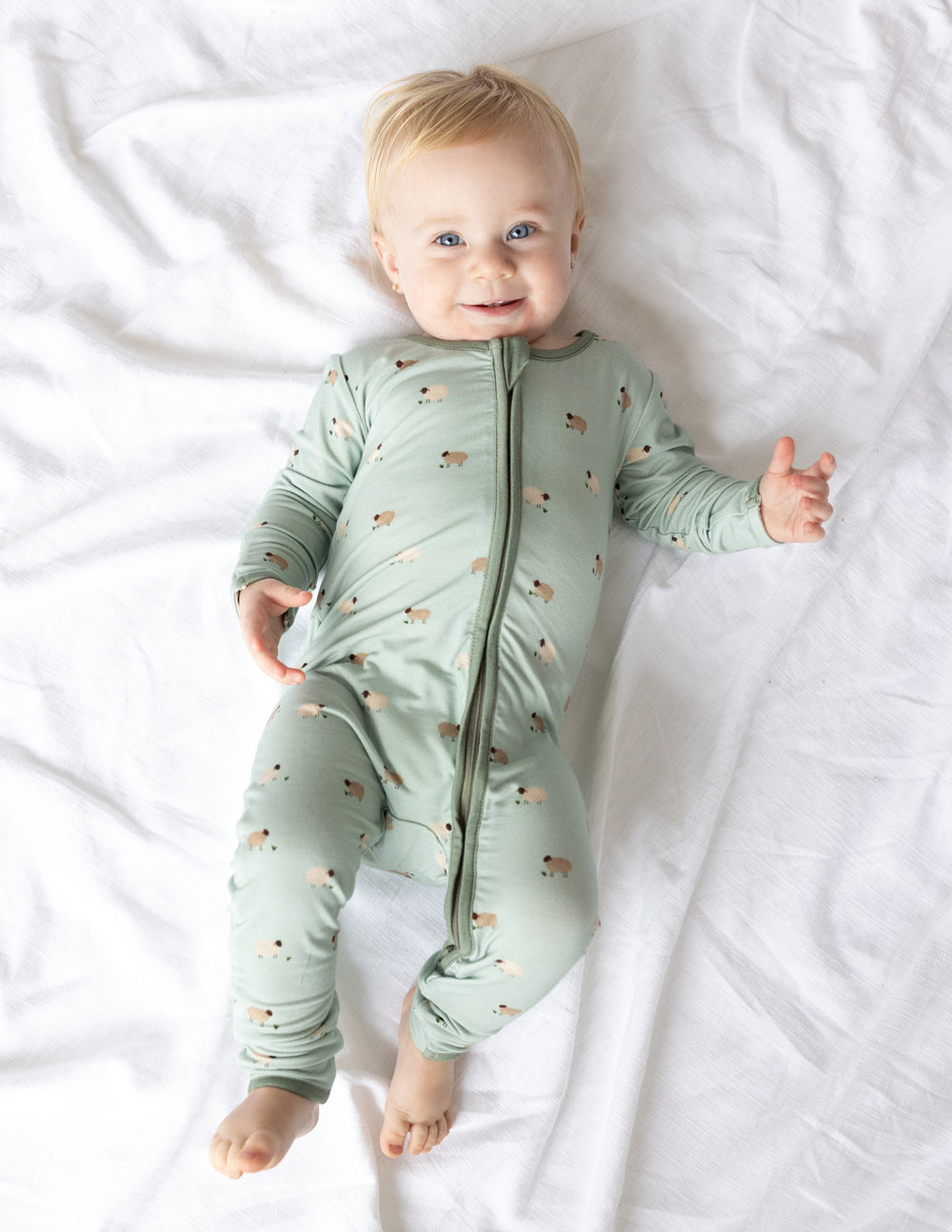 Elevated Faith Christian Kids Apparel featuring a cute green onesie with playful animal prints