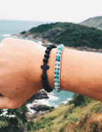 Stone Bracelet stack featuring a black cross and turquoise beads, part of Elevated Faith's Christian Jewelry Bracelet collection