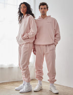 Couple wearing light pink Elevated Faith Christian Hoodie with matching sweatpants for a stylish look