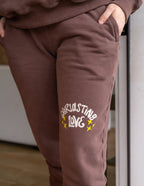 Brown Elevated Faith Sweatpants featuring 'Overflowing Love' design, perfect for Christian Apparel